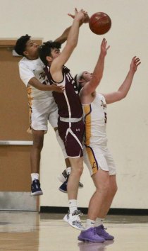 Lemoore's Diego Ambriz (13) and Will Schalde (5) block a shot in the first half of Wednesday's game against visiting Mt. Whitney.